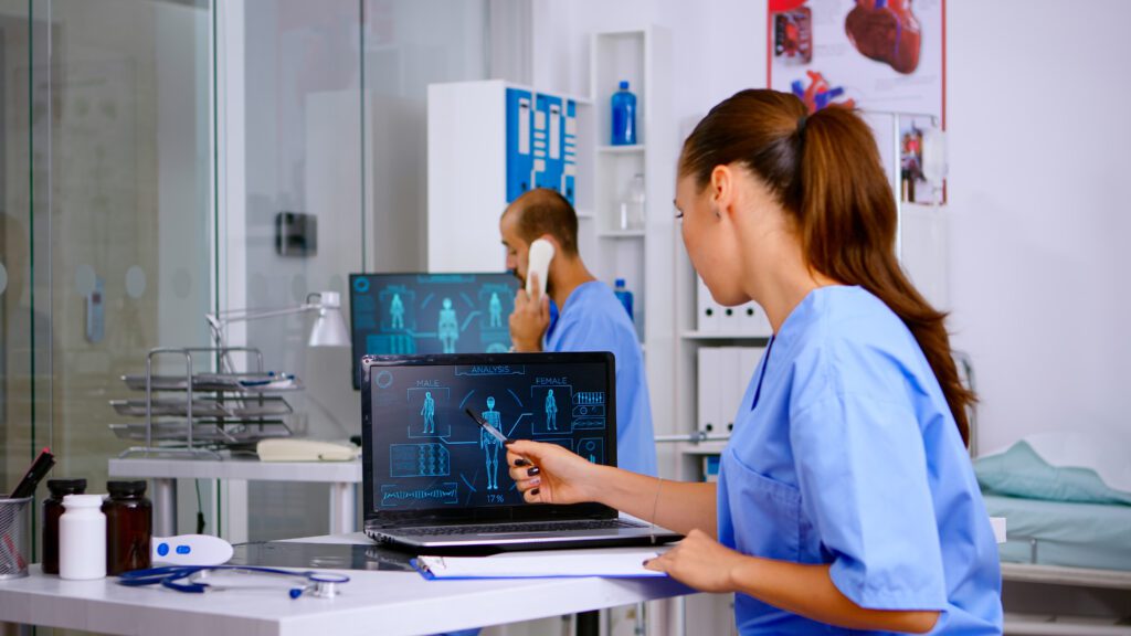 Student medical practitioner analysing human body digital scan, holding radiography sitting in hospital. Radiologist in medicine uniform looking at x-ray, examination, bone, practitioner, diagnosis.